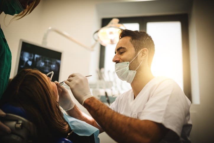 dentist performing bone grafting procedure