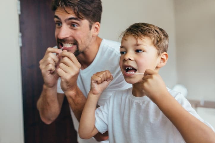 dad and son flossing